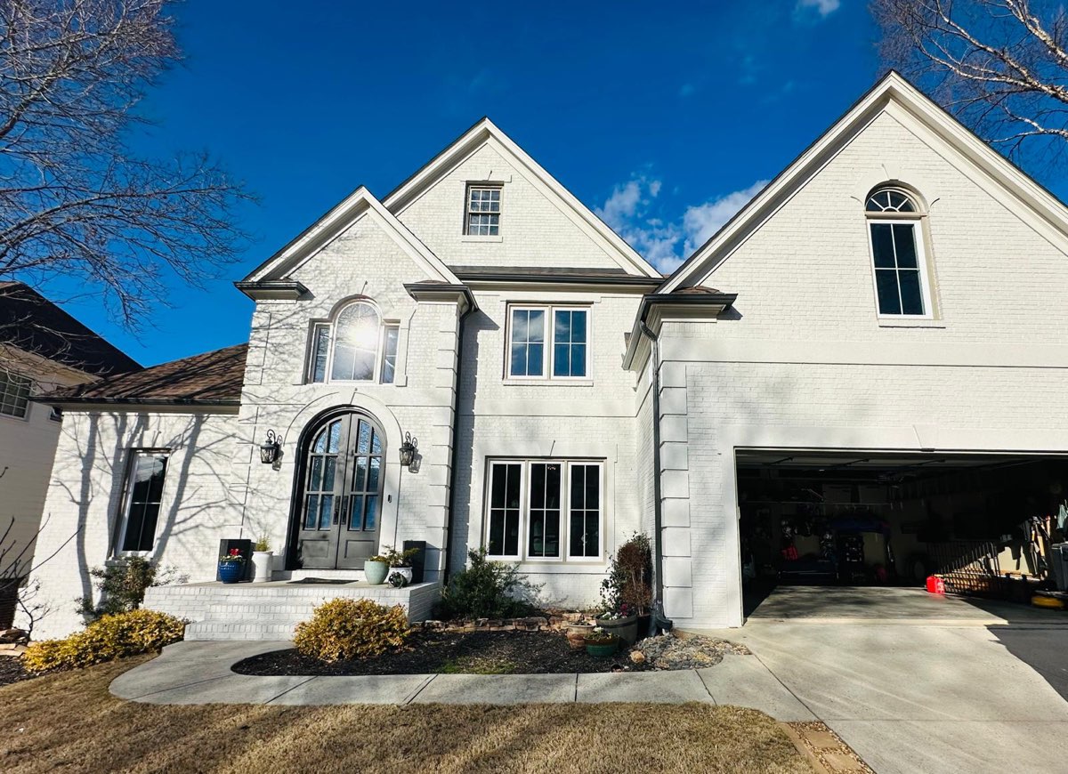 Painted brick home with new arched and casement windows — East Cobb, GA